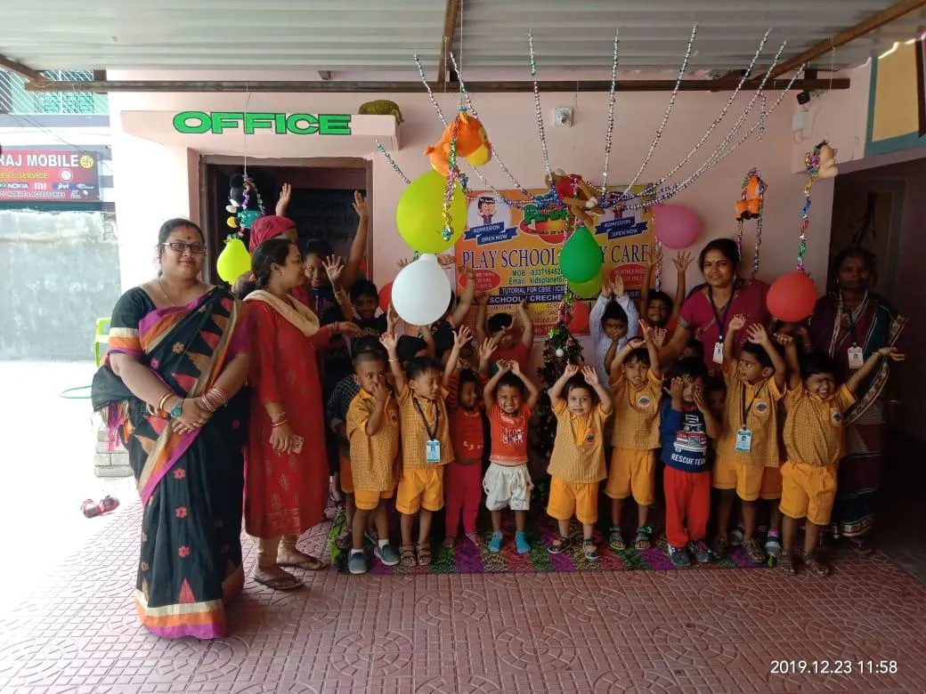Children and teachers celebrating at Kids Planet