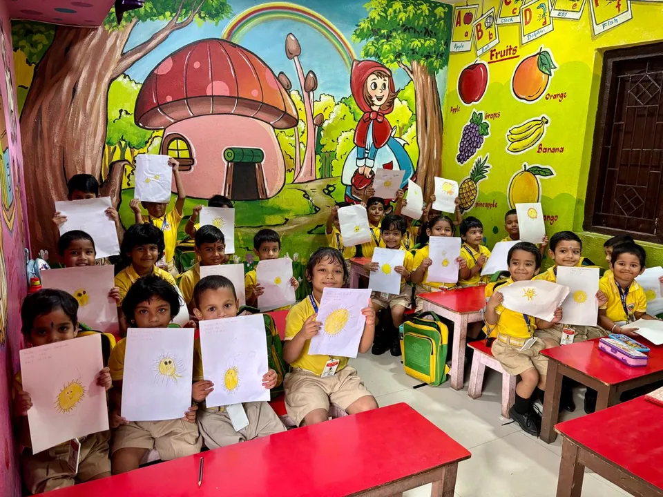 Children showing their sun drawings in a Kids Planet classroom in Old Town, Bhubaneswar